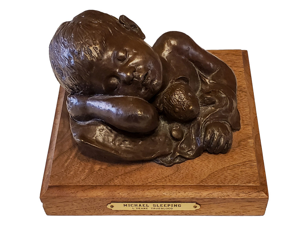 Photo of a bronze sculpture titled "Michael Sleeping" by Utah painter and sculptor L'Deane Trueblood