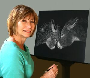 Photo of scratchboard artist Deborah Liszt at work on an image